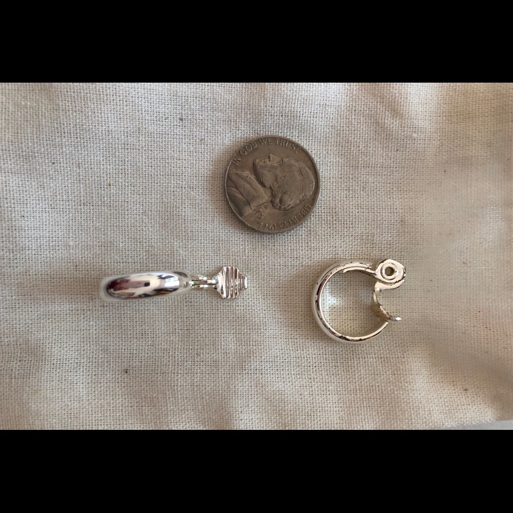 Clips silver tone hoops. Never worn.